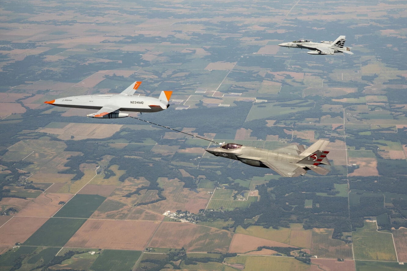 drone refueling an F 35 fighter in the air