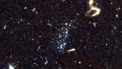 Mysterious blue spots may have formed as a result of falling galaxies on their belly