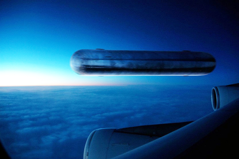 Cigar shaped UFO over California captured from a passenger plane 1